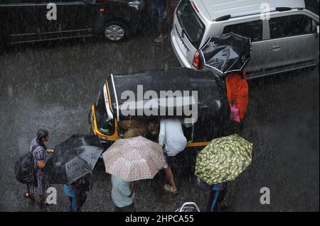 Mumbai; Maharashtra; India- Asia, June, 2019 : Blurred image, Aerial view, man entering in riksha in heavy rain Stock Photo