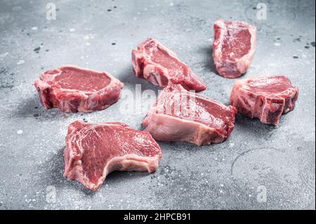 Raw fresh lamb loin chops cutlets. Gray background. Top view Stock Photo