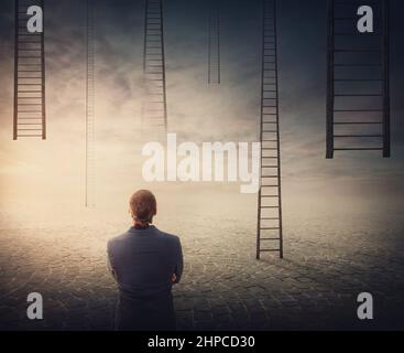 Businessman in front of multiple ladders leading up to the sky. Business challenge, choice and opportunity concepts Stock Photo