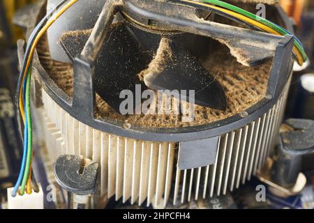 Old computer system unit with spider web and dust inside. Stock Photo