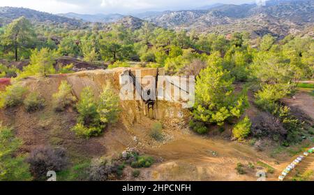 Historical copper mining area since antiquity in Kalavasos, Cyprus. Ore bin and mine tailings from 1950s, and hills of Roman slug behind them Stock Photo