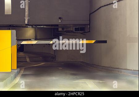 Barrier in an underground parking. At the Basement Parking, carpark with signboard and details. Parking Entrance, Closed barrier. Concept closed Stock Photo