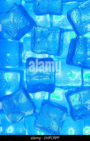 Ice cubes with blue backlight in the freezer close-up in full screen selective focus Stock Photo