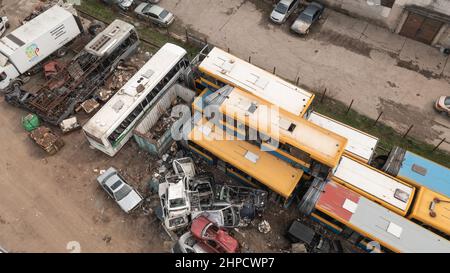 Old cars and public busses in the junkyard waiting to be dismantled and scrapped Stock Photo