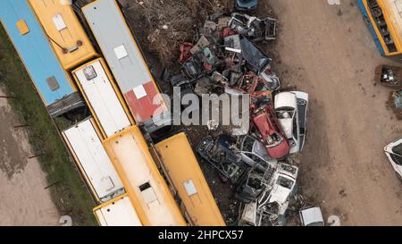 Rusty cars and busses in the junkyard waiting to be dismantled and scrapped Stock Photo