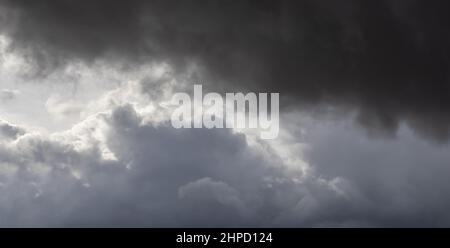 overcast, storm clouds in the sky partly illuminated by the sun Stock Photo
