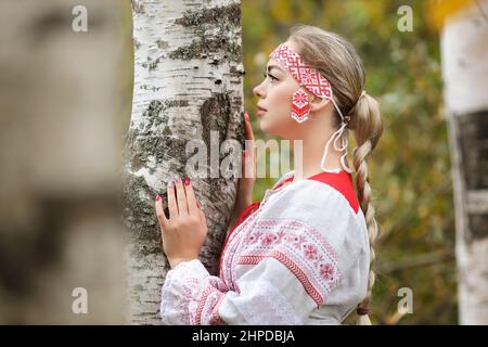 Traditional Russian folk costume, portrait of a young beautiful blonde girl  in red dress, isolated on white background Stock Photo - Alamy