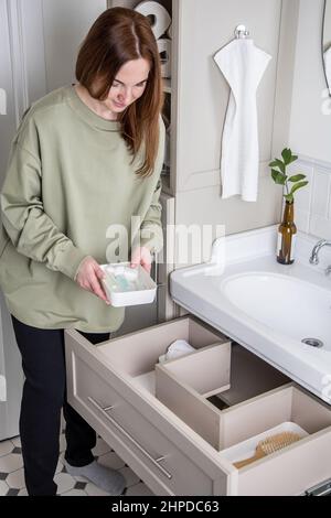 Bathroom under sink organizer drawers with neatly placed bath amenities and  toiletries Stock Photo - Alamy