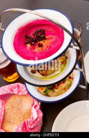 Three meze dishes served on rack Stock Photo