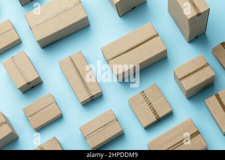 Lots of cardboard boxes pattern on a blue background. Top view. Stock Photo