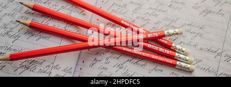 IELTS red pencils and essay notebook for the English exam Stock Photo -  Alamy