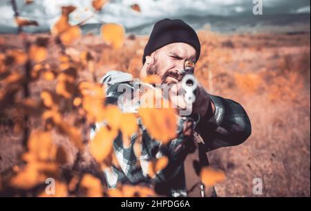 Autumn hunting season. Close up snipers carbine at the outdoor hunting. Hunter with shotgun gun on hunt. Hunting without borders. Poacher in the Stock Photo