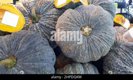 Several pumpkins were placed on the shelf. Some pumpkins were cut in half and had a white label attached to them. Stock Photo