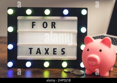 For taxes phrase written on marquee lightbox - savings for tax concept. High quality photo Stock Photo