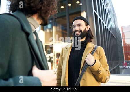 Two gay people meet on the street on their first date after meeting on a dating app. Stock Photo