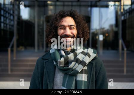 Young Caucasian businessman looking camera smiling. Cheerful male happy for the successes of work. Stock Photo