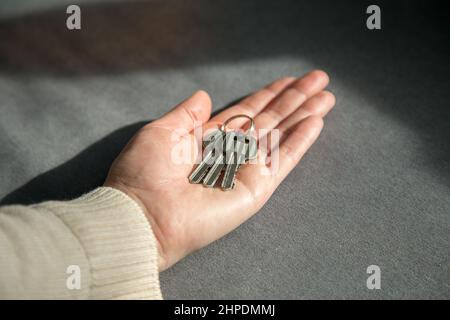 Close up shot of keys on a woman's palm. The concept of property, real estate and buying property Stock Photo