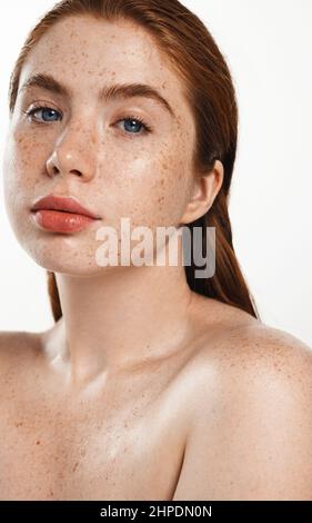 Skin care. Curvy redhead woman with beauty face and healthy facial skin