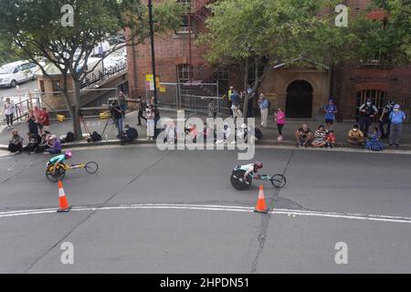 Wheelchair Racers going past Spectators lining the Street Stock Photo