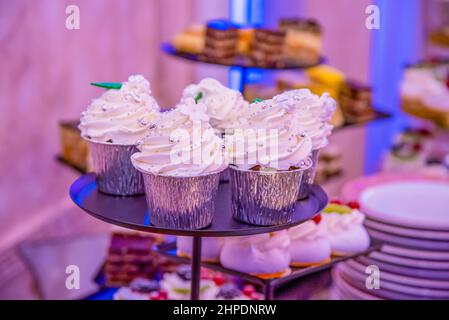 variety of cupcakes on a brown plate Stock Photo