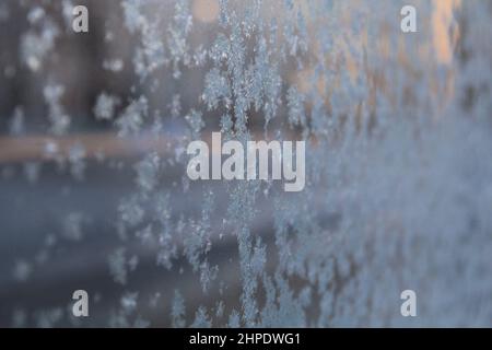 Closeup of Ice pattern on a glass frozen window on a winter day Stock Photo