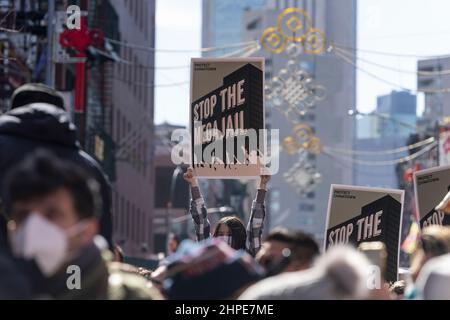 New York, USA. 20th Feb, 2022. Atmosphere during Lunar New Year parade in Manhattan Chinatown in New York on February 20, 2022. Thousands of people participated and watched the parade along the streets of Chinatown. Lion dance, dragon dance, flags of the USA and People's Republic of China, floats and some political statements were seen on the parade route. Participants hold posters against building new jail in Chinatown. (Photo by Lev Radin/Sipa USA) Credit: Sipa USA/Alamy Live News Stock Photo