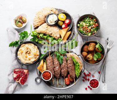 Lebanese food assortment on light background. Traditional food concept. Top view, flat lay Stock Photo
