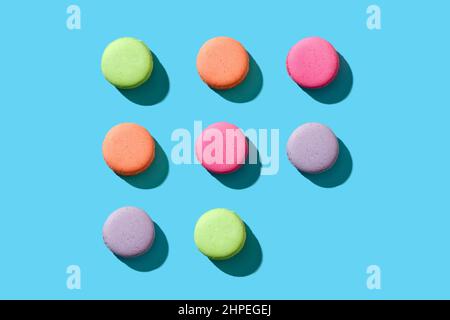 Pastel colored macaroons or macarons aligned in a repetitive incomplete pattern with one of them is missing Stock Photo