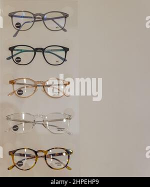 Several trendy stylish glasses on a beige background. Stylish eyeglasses over pastel background. Optical store. Stock Photo