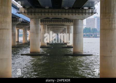Under the Mapo Bridge on the Han River in the Korean capital Seoul. Along the Han River Walking Paths people relaxing and even camping on the river ba Stock Photo