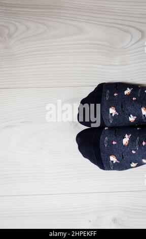 man wearing stylish socks standing on floor, top view. Space for text Stock Photo