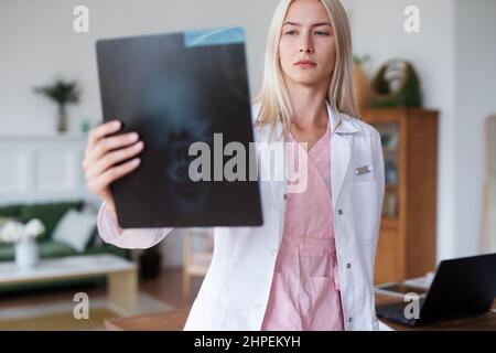 Woman doctor looking at an X-ray image. Stock Photo