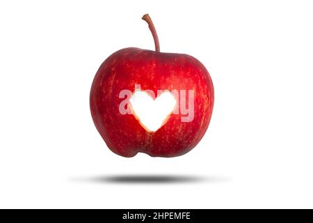 Love heart cut through a red apple isolated on a white background. Love fresh fruit concept Stock Photo