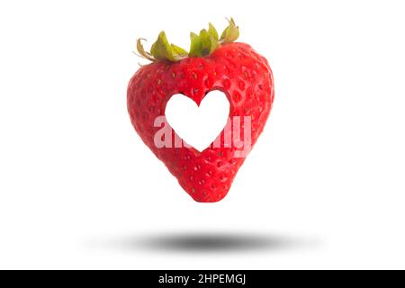 Love heart cut through a red strawberry isolated on a white background. Love fresh fruit concept Stock Photo