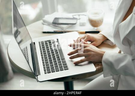 Closeup of a female hands busy typing on a laptop. Woman working at laptop computer hands close up. Working at home. Quarantine and Social distancing Stock Photo