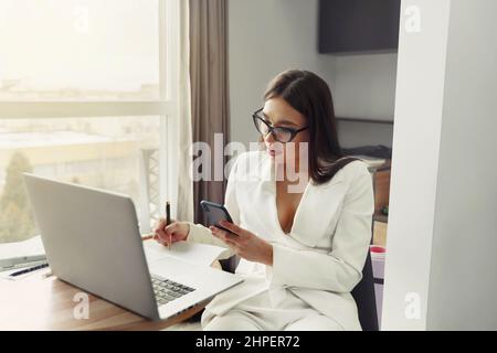 Businesswoman working on laptop computer. Woman sitting at office managing her business Stock Photo