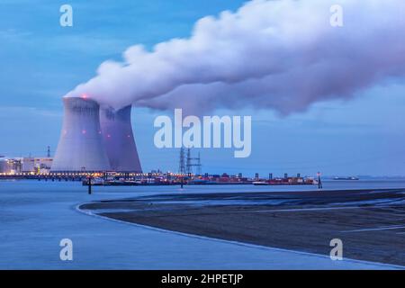 Riverbank with nuclear power plant Doel at twilight, Port of Antwerp, Belgium Stock Photo