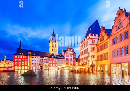 Trier, Germany. Main Market, Hauptmarkt at night. It is the center of the medieval Trier surrounded by numerous historic buildings, St. Gangolf church Stock Photo