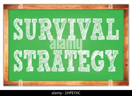 SURVIVAL STRATEGY written on green wooden frame school blackboard Stock Photo