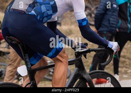 rear view of an unrecognizable cyclist at maximum effort during a race.  Stock Photo