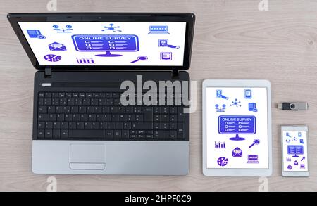 Online survey concept shown on different information technology devices Stock Photo