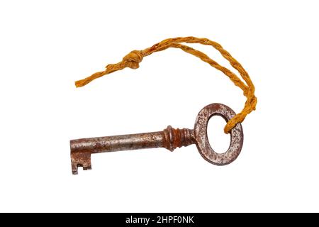 Vintage keys isolated. Close-up of an old rusty key of an old large padlock hanging on a string isolated on a white background. Antique objects. Macro Stock Photo