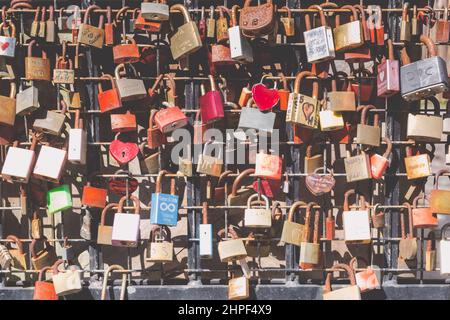 Goes, The Netherlands - May 30, 2021: Background with colorful locks of love hanging on gate Stock Photo