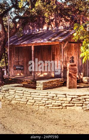 Old post office and general store at Luckenbach, Texas.  In front is a bronze bust of Hondo Crouch, who made it famous. Stock Photo