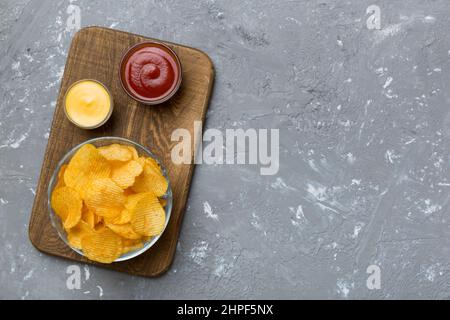 Top View Chips With Sause In Bowl On Colored Background, Top View With 