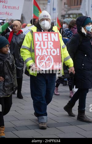 Munich, Germany. 19th Feb, 2022. Participant with sign „No to Nato“. On February 19, 2022, thousands of participants gathered to demonstrate against the Munich Security Conference, against war & NATO and for peace. This year at the MSC, topics such as the Russia-Ukraine conflict are dealt with without Russia taking part in it. (Photo by Alexander Pohl/Sipa USA) Credit: Sipa USA/Alamy Live News Stock Photo