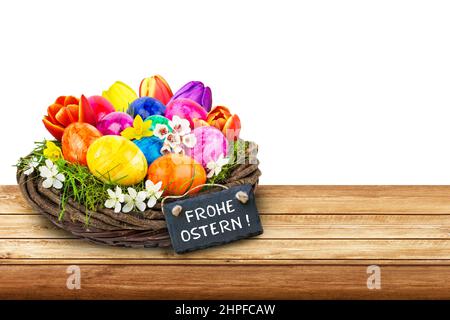 Easter decoration eggs with label and German Happy Easter on wooden board isolated on white background Stock Photo
