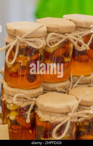 Honey jar with dried fruits and nuts Stock Photo