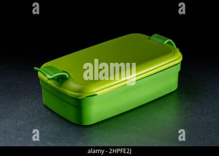 green lunchbox made of plastic in dark back Stock Photo