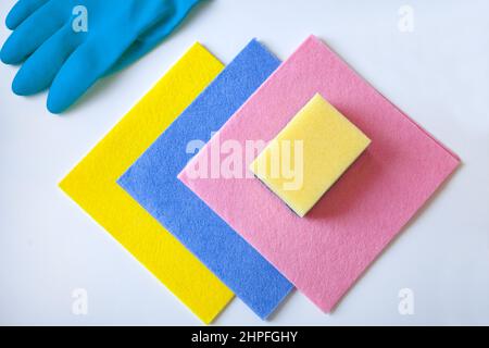 cleaning rugs and glove-colorful sponges, rubber gloves for cleaning on a white background, flat lay. Stock Photo